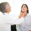 Doctor endocrinologist testing young woman patient at office