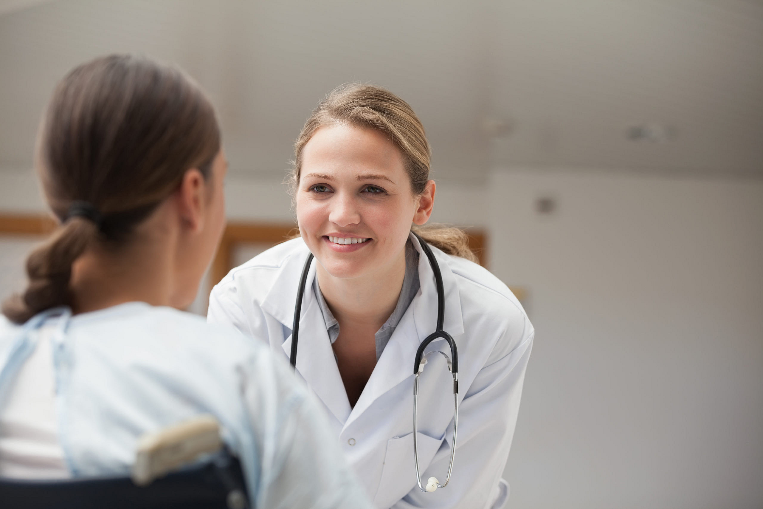 Female doctor checking on a female patient during a wellness exam