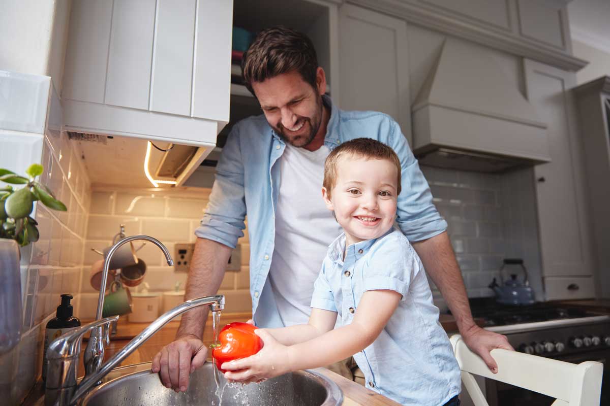 Father and child wash vegetables for food, nutrition or learning healthy diet