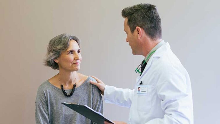 Male physician consulting with an adult female patient